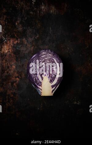Top view of a lilac cabbage cut in half on rustic wooden background Stock Photo