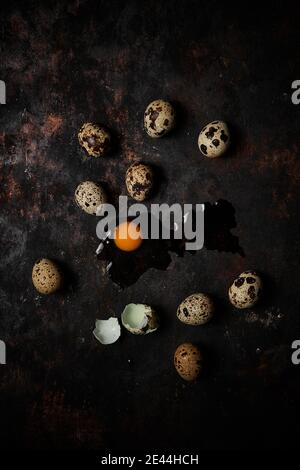 Top view of a group of quail eggs on dark rustic wooden background Stock Photo