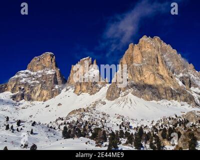 Majestic Snowy Rock in Selva di Val Gardena. Top of the Rocks in Winter Dolomites Italy with Deep Blue Sky. Stock Photo