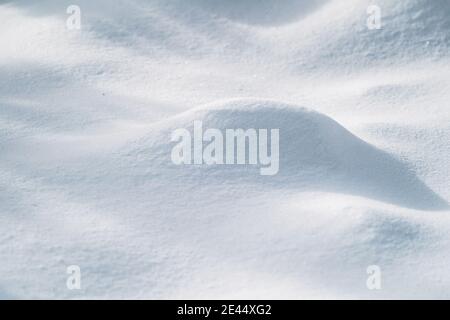 From above of smooth surface of white snow on sunny winter day as background Stock Photo