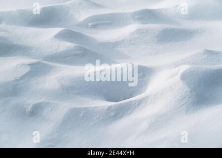From above of smooth surface of white snow on sunny winter day as background Stock Photo