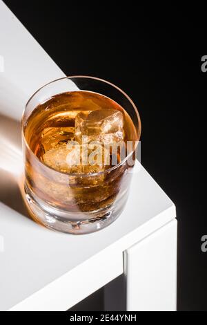 Alcohol Old fashioned cocktail with whiskey and bitters garnished ice cube served in glass Stock Photo