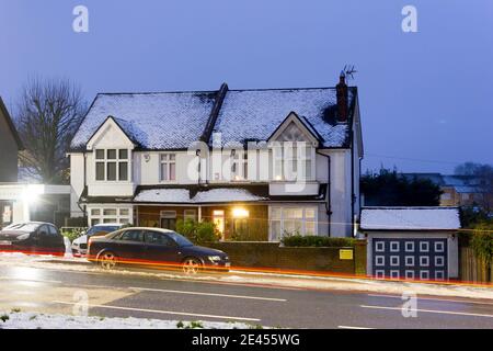 Semi detached house covered in light snow over night in cold January, winter month, London, England UK Stock Photo