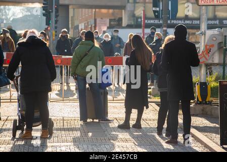 Prague, Czech Republic. 01-21-2021. People waiting for the train to go through so they lift the train barriers, in the center of Prague during a sunny Stock Photo