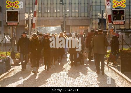 Prague, Czech Republic. 01-21-2021. People waiting for the train to go through so they lift the train barriers, in the center of Prague during a sunny Stock Photo