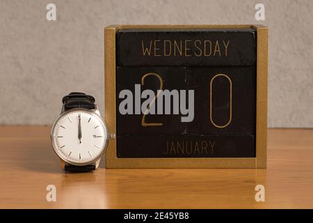 time of presidential inauguration, united states, wooden calendar january 20th, watch 12:00 p.m. Stock Photo
