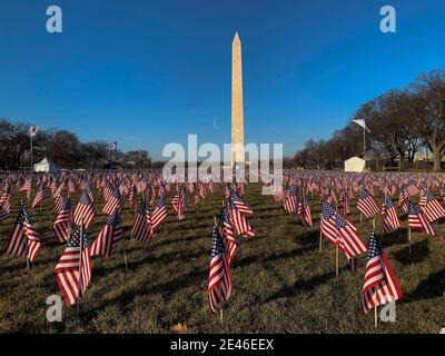 Washington, District of Columbia, USA. 21st Jan, 2021. Early morning sunlight lit a field of United States flags that were part of the 'Field of Flags' on the National Mall. Nearly 200,000 flags was planted on the Mall to fill in for the thousands of people who could not attend because of the coronavirus pandemic and tight security. They represented the 50 states, the District of Columbia, and the five U.S. territories of American Samoa, Guam, Northern Mariana Islands, Puerto Rico and the U.S. Virgin Islands. Credit: Sue Dorfman/ZUMA Wire/Alamy Live News Stock Photo