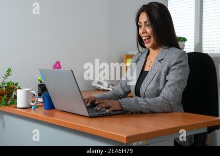 Closeup shot of an attractive young female smiling and working in the office Stock Photo