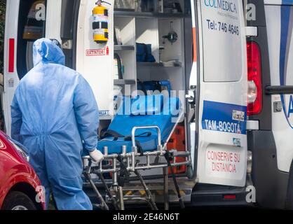 Bogota, Colombia. January 21, 2021: A nurse carries the stretcher into an ambulance in front of a clinic north of Bogota. This Friday the city at 8 pm will again be in total quarantine all weekend until Monday at 4 am Credit: Daniel Garzon Herazo/ZUMA Wire/Alamy Live News Stock Photo