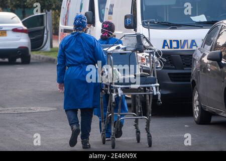Bogota, Colombia. January 21, 2021: Some nurses carry a stretcher in front of a clinic north of Bogota. This Friday the city at 8 pm will again be in total quarantine all weekend until Monday at 4 am Credit: Daniel Garzon Herazo/ZUMA Wire/Alamy Live News Stock Photo