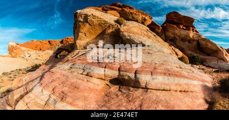Striped Sandstone Slick Rock and Thunderstorm Arch, Valley of Fire State Park, Nevada, USA Stock Photo