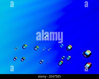Close-up of water drops on a coloured surface Stock Photo