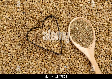 Cannabis seeds with a heart. ground Organic Hemp seed. texture. Hemp seeds background Stock Photo