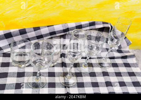 Set of glasses for different alcoholic drinks on yellow background. Empty clear glassware. Stock Photo