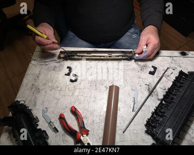 Closeup of the male technician's hands repairing the printer Stock Photo
