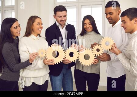 Multiracial colleagues learn to collaborate, plan and find solutions in team building training. Stock Photo