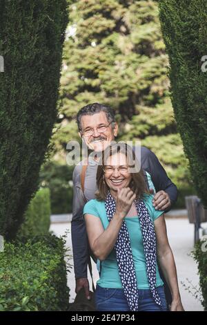 Portrait of a cute middle-aged couple smiling in a park Stock Photo