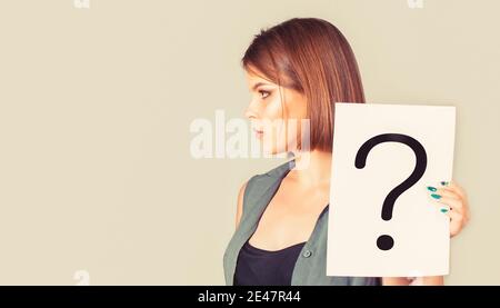 Question mark, symbol. Concept - challenging issue, looking for the answer. Woman with doubtful expression and question marks. Copy space. Thinking Stock Photo