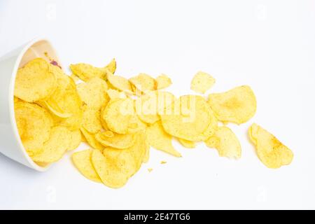 Potato chips falling into bowl isolated on white background Stock Photo