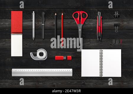 Stationery, office supplies mockup template, isolated on black wood background Stock Photo