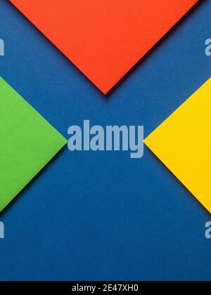 Colorful paper design with red, yellow and green triangles on a blue background, web design resources. Stock Photo