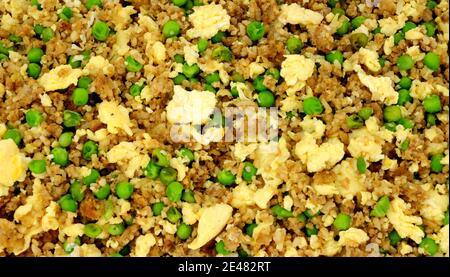 Chinese egg fried rice with peas background Stock Photo
