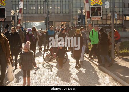 Prague, Czech Republic. 01-21-2021. People waiting for the train to go through so they lift the train barriers, in the center of Prague during a sunny Stock Photo