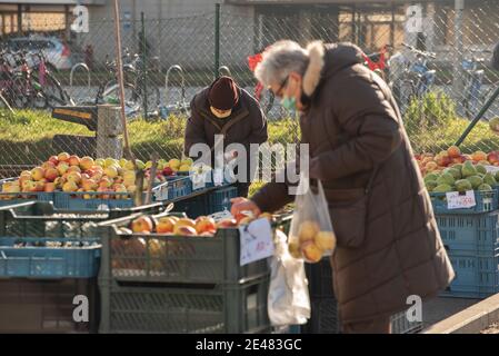 Prague, Czech Republic. 01-21-2021. People bying fruits and vegetables at the market, in the center of Prague during a sunny winter morning. Stock Photo