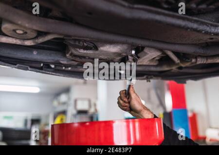 Hands of a mechanic changing the oil of the car. concept car mechanics Stock Photo
