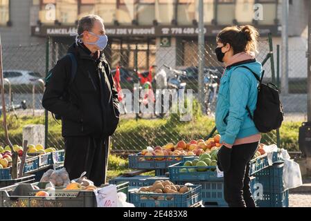 Prague, Czech Republic. 01-21-2021. Couple talking in the fruit and vegetable market in the center of Prague during a sunny winter morning. Stock Photo