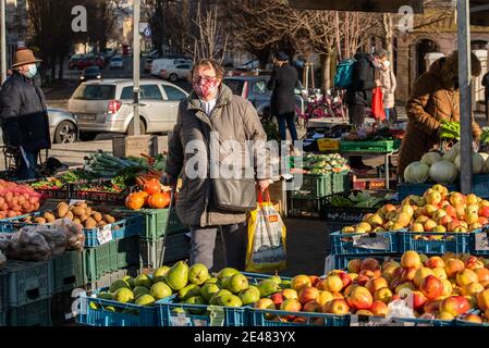 Prague, Czech Republic. 01-21-2021. People bying fruits and vegetables at the market, in the center of Prague during a sunny winter morning. Stock Photo