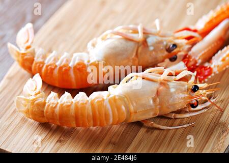 Raw scampi on cutting board . High quality photo. Stock Photo