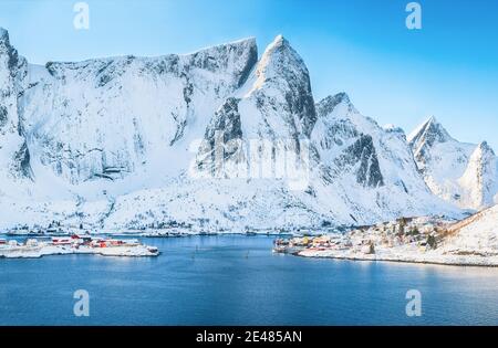 Fabulous winter view of Reine village  seen from Olenilsoya island with Hammarskaftet peak and snowy mountaines in background .  Location: Olenilsoya Stock Photo