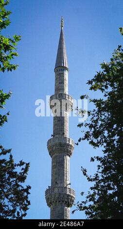 Vertical shot of one of the six minarets in Istanbul against the clear blue sky Stock Photo