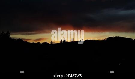 Sunset with dark storm clouds Stock Photo