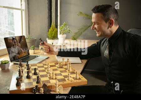 Premium Photo  Woman playing chess online uses laptop