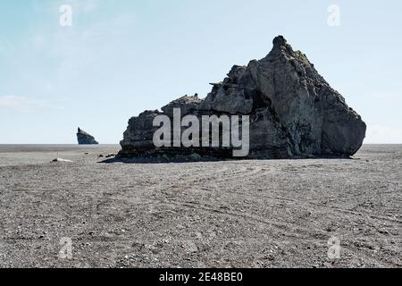 The strange lunar like black sand plain and volcanic rock pillar landscape of Mýrdalssandur near Vik south Iceland. Stock Photo