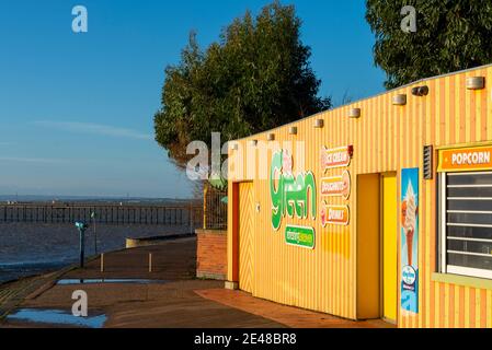 The Green, take away cafe on Southend on Sea seafront on a bright winter day. Bright striped building. Blue sky Stock Photo