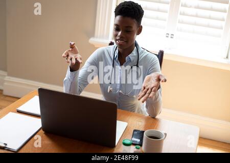 African american female doctor making video consultation call using laptop Stock Photo