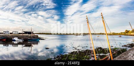 A peaceful evening on the quayside at Kinvara Bay, with Dunguaire Castle in the distance, Kinvara, County Galway, Ireland Stock Photo
