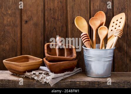various kitchen utensils on wooden shelf Stock Photo