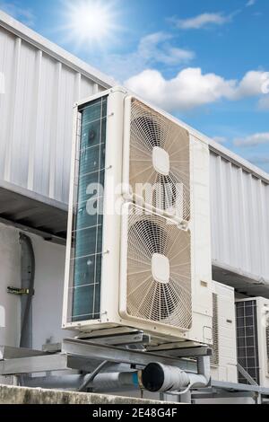 Air compressors installed outdoors with sky and sunlight background. Stock Photo