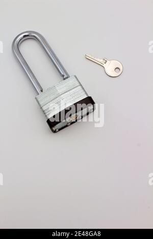 A steel  padlock and key isolated on plain white background a concept of safety and security Stock Photo