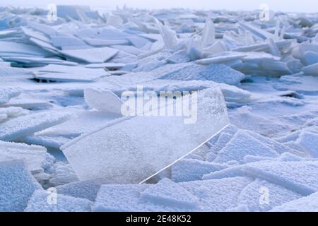 Cracked and re-frozen blue ice on the river. Eastern Europe. Landscape. Background texture. Horizontal orientation. Stock Photo