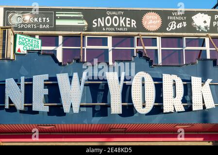 New York amusement arcade early in the morning on a sunny day on Marine Parade, Southend on Sea, Essex, UK. Sports bar, snooker hall Stock Photo