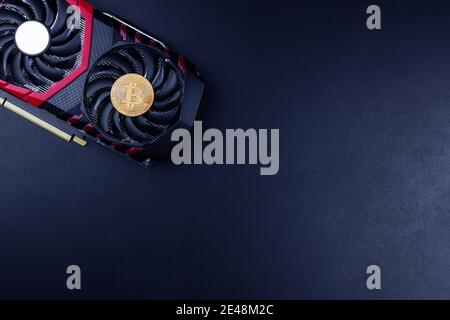 Bitcoin. New virtual money. Bitcoins lie on the video card, concept of mining. Blockchain and mining concept. Stock Photo