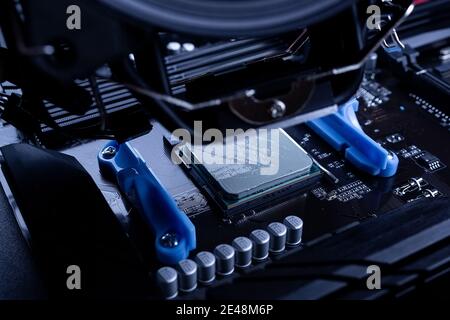 Assembly and maintenance of the computer, connecting the fan to the motherboard Stock Photo