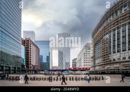 Canary Wharf London Lockdown essential workers commuting through the financial district with sky scrapers and financial district Stock Photo