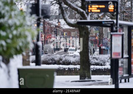 Sutton in Ashfield Outram Street severe weather snow fall snowy scene falling heavy deep covered road pavement Nottinghamshire Mansfield cars bus stop Stock Photo