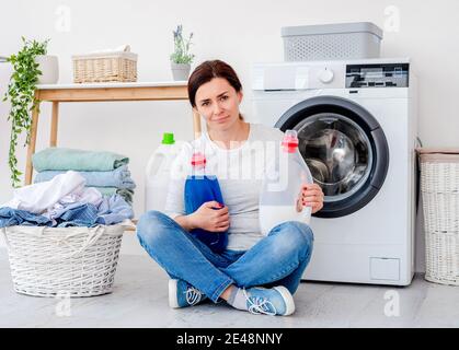 Woman holding bottles with gel and softener Stock Photo